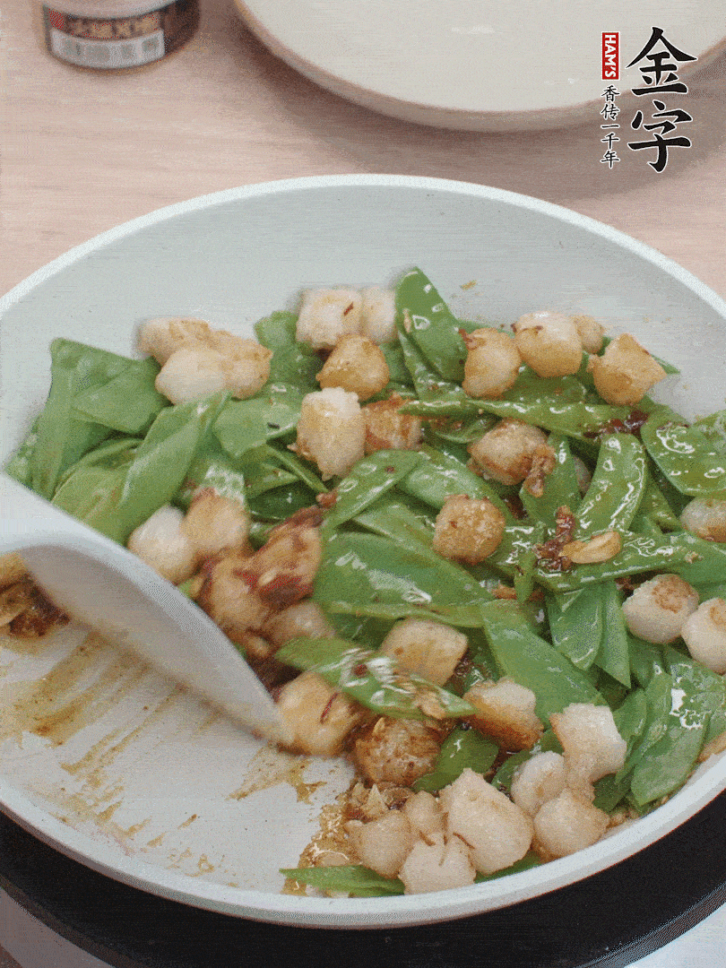 下甜豆莢、鮮貝輕輕翻炒均勻。