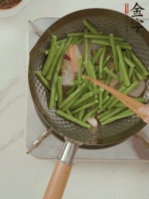 下掰好的缸豆段翻炒，略燜煮。